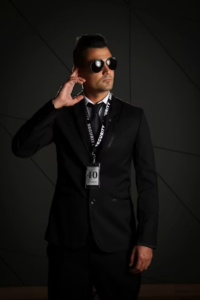 Security officer in a suit wearing an earpiece and security lanyard
