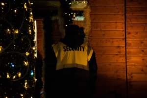 Security guard standing watch at a holiday event or market at night
