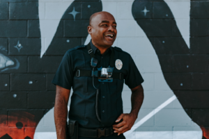 A private security guard greeting visitors at an entry point.